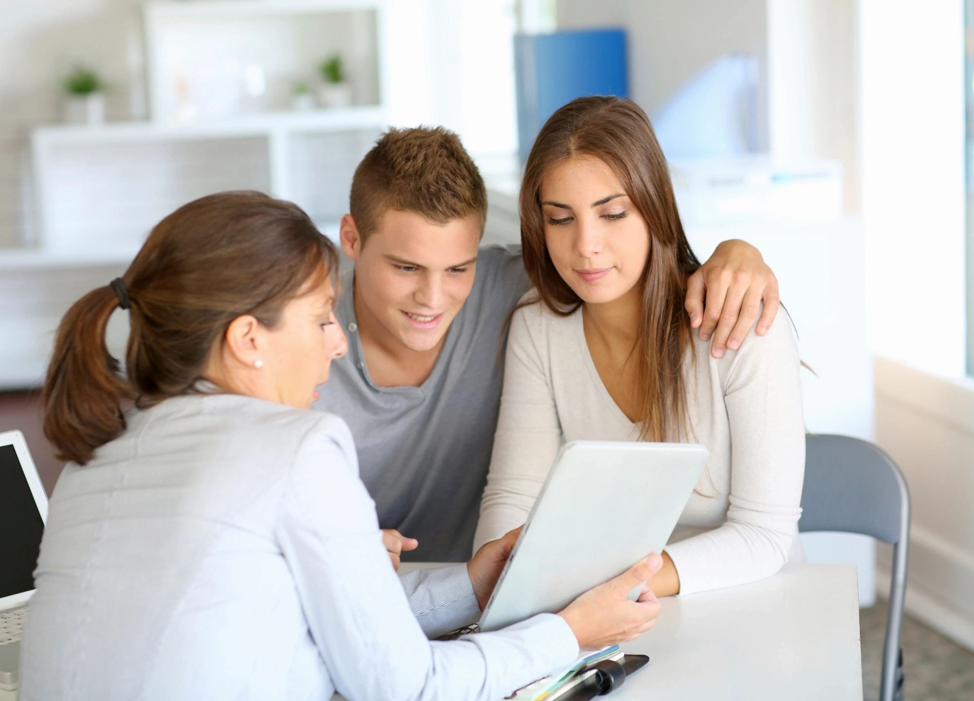 Professionals reviewing tablet in modern office