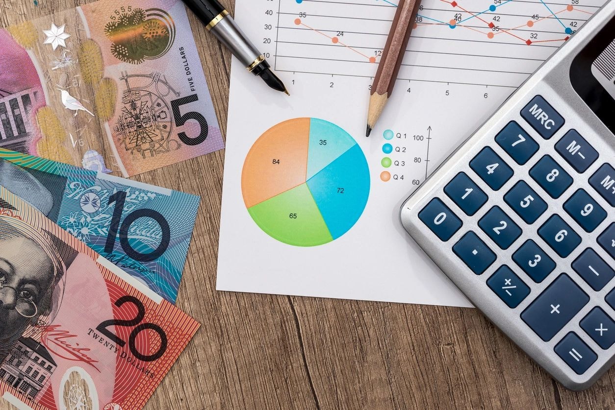 Australian currency and financial charts flat lay